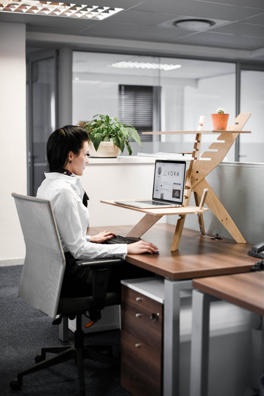 VORM Deskstand in use by woman while sitting